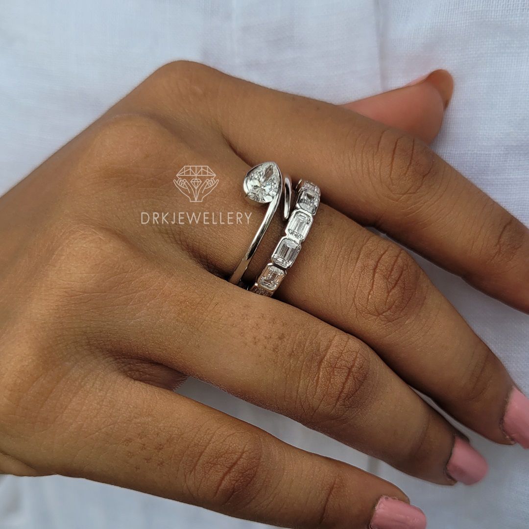 Bezel Set Pear Cut Lab Grown Diamond Ring With East West Emerald Band