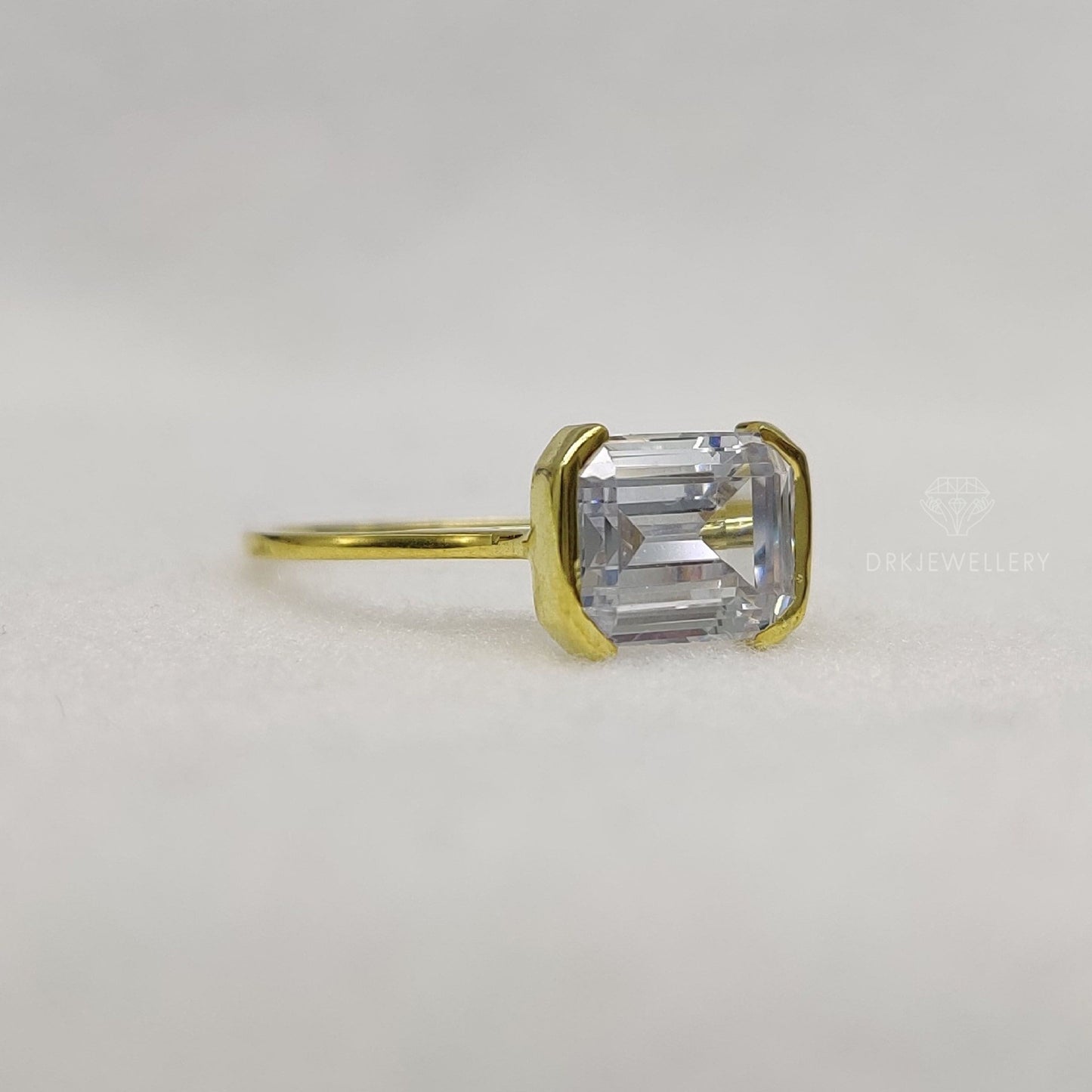 East West Emerald Cut Moissanite Half Bezel Set Gold RIng
