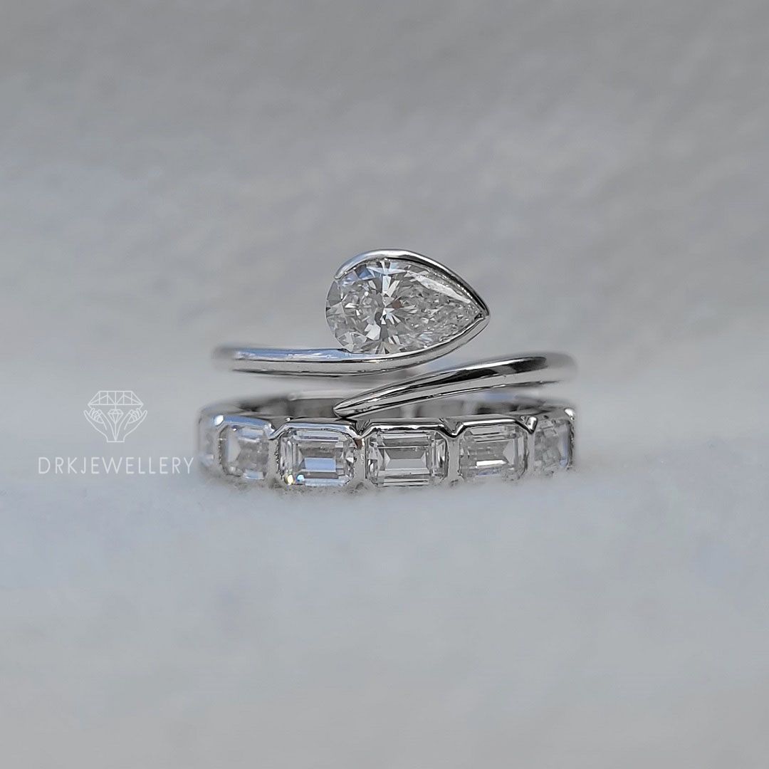 Bezel Set Pear Cut Lab Grown Diamond Ring With East West Emerald Band