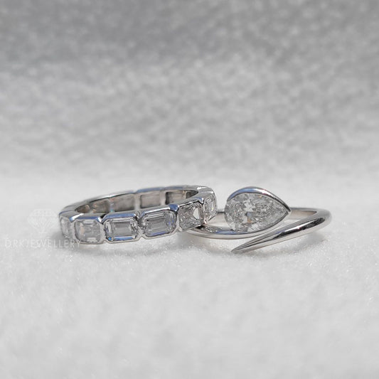 Bezel Set Pear Cut Lab Grown Diamond Ring With East West Emerald Band