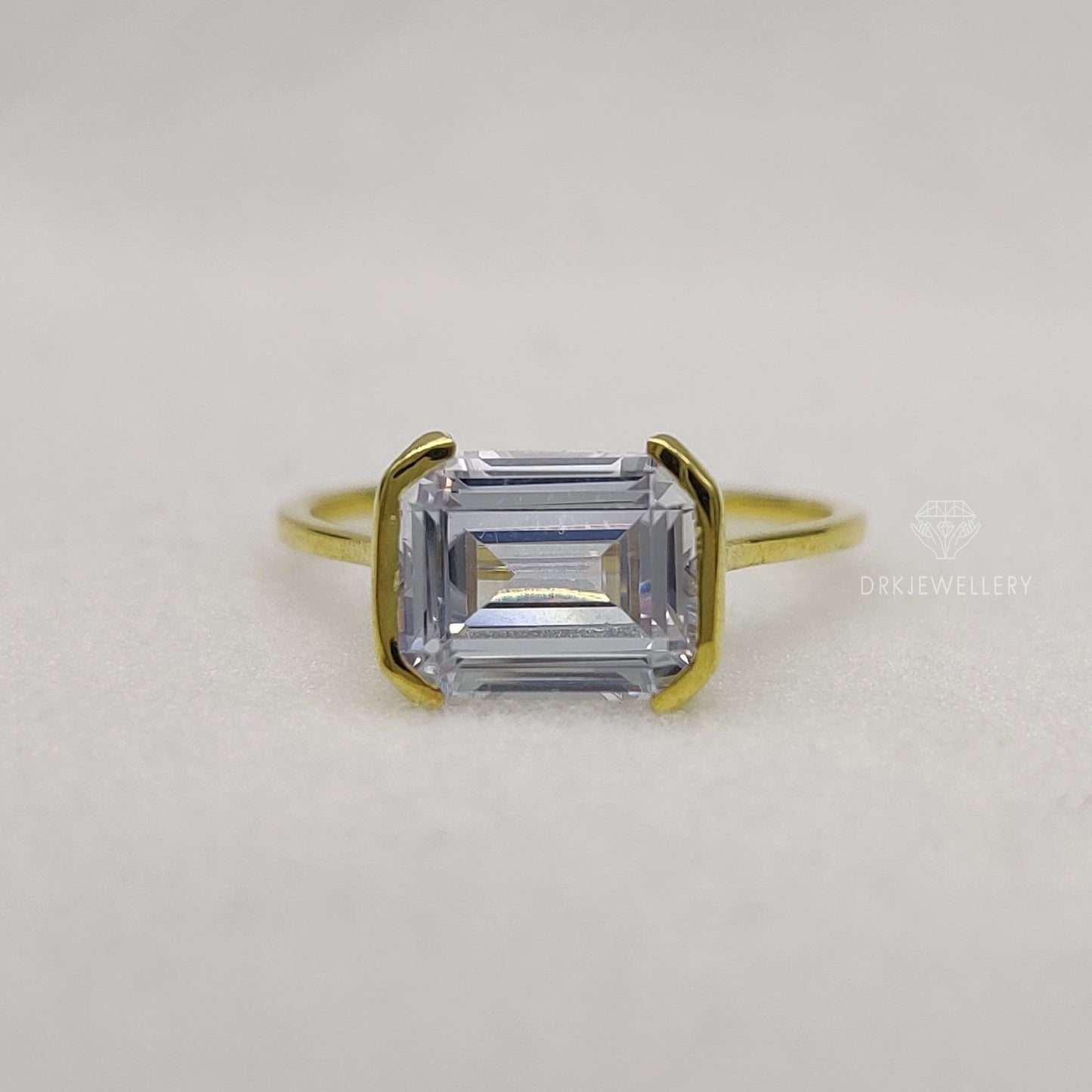 East West Emerald Cut Moissanite Half Bezel Set Gold RIng
