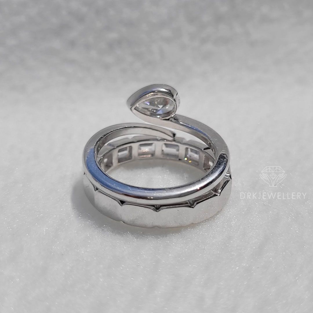 Bezel Set Pear Cut Lab Grown Diamond Ring With East West Emerald Band