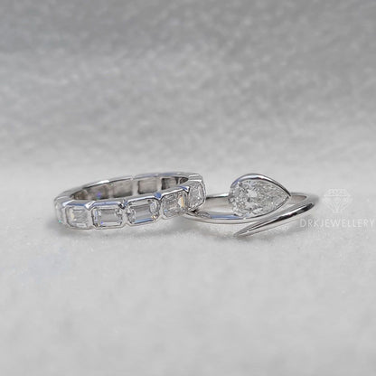Bezel Set Pear Cut Lab Grown Diamond Ring With East West Emerald Band